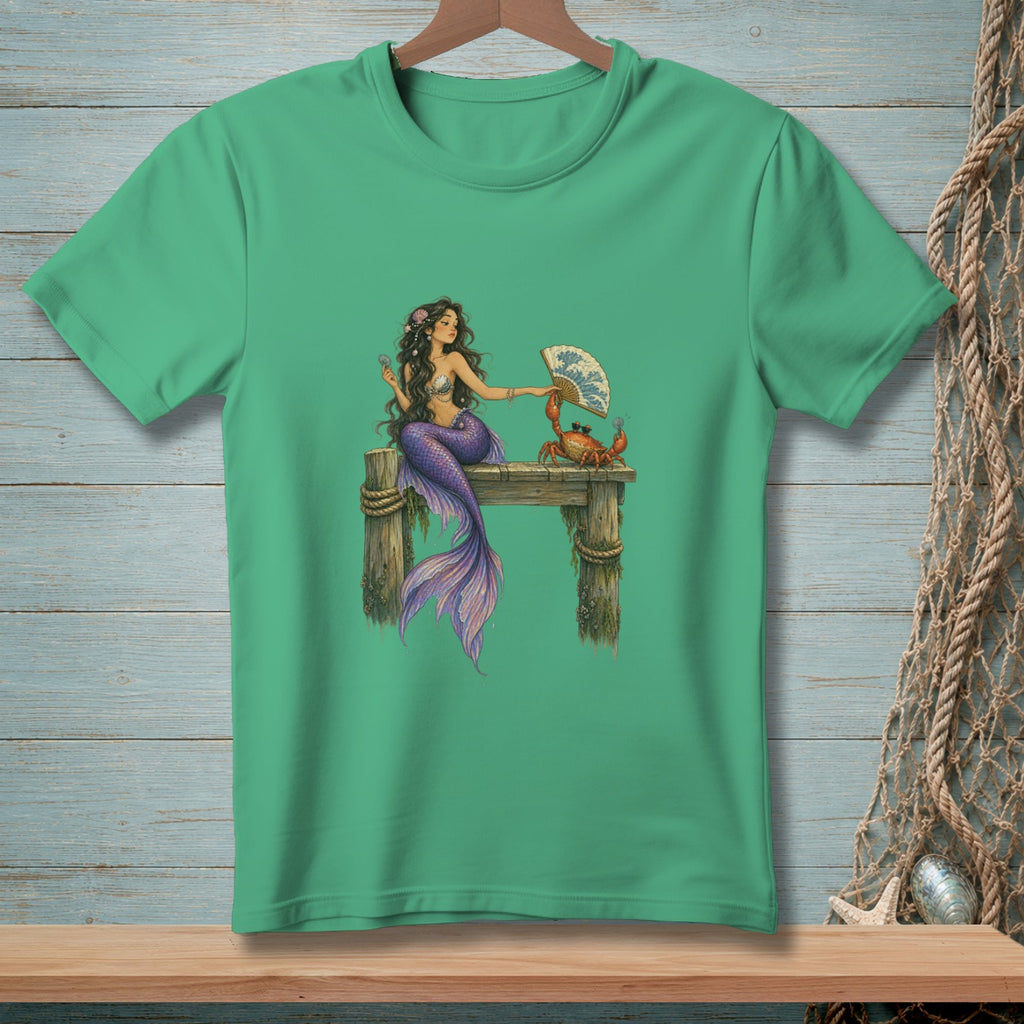 Mermaid with purple tail interacting with a crab and fan on wooden pier.
