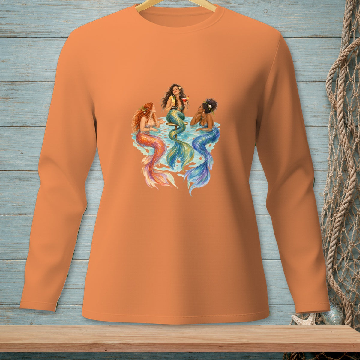 Three mermaids with colorful tails relax and drink cocktails in the water.