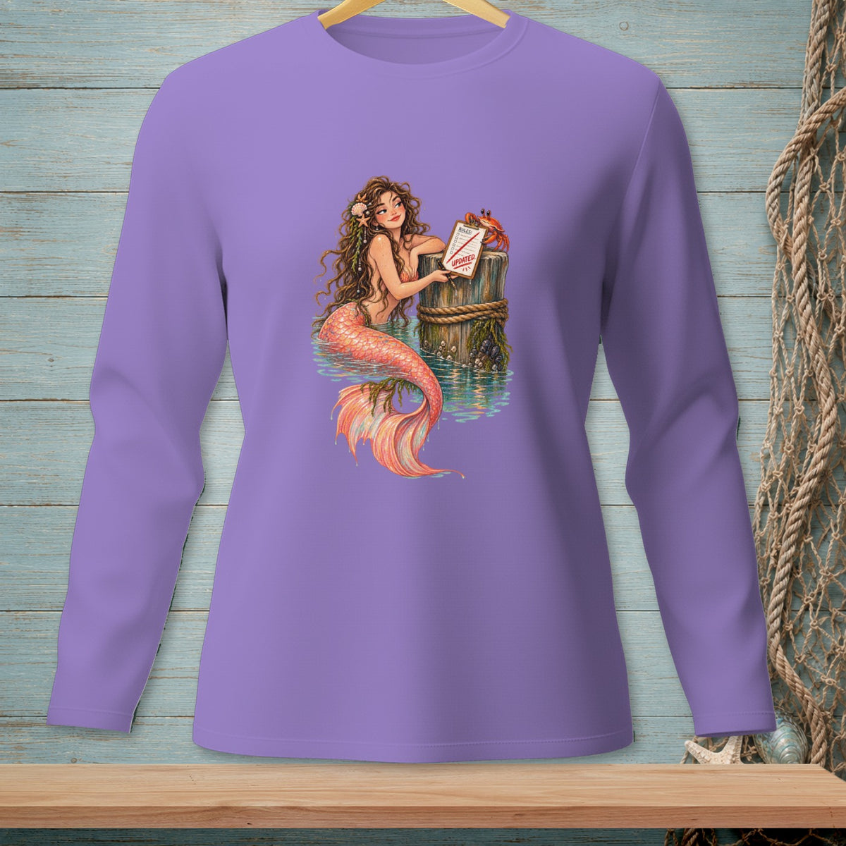 Mermaid by a dock with crab and updated sign on a purple long-sleeve shirt.