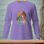Two mermaids sitting on a dock, one looking in a mirror.