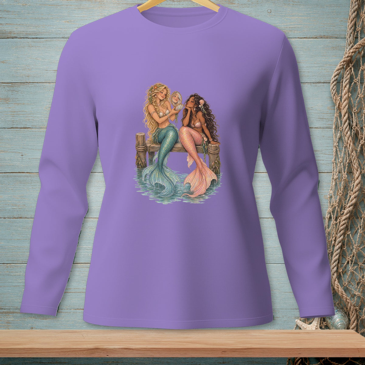 Two mermaids sitting on a dock, one looking in a mirror.
