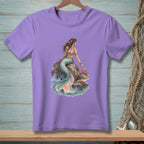 Purple t-shirt with a watercolor mermaid and crab on a rock by the sea.
