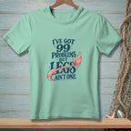 Mint t-shirt with "I've Got 99 Problems But Legs Ain't One" text and mermaid tail.
