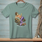 Mermaid with cucumber eye masks relaxes on rocks with a drink and a crab.