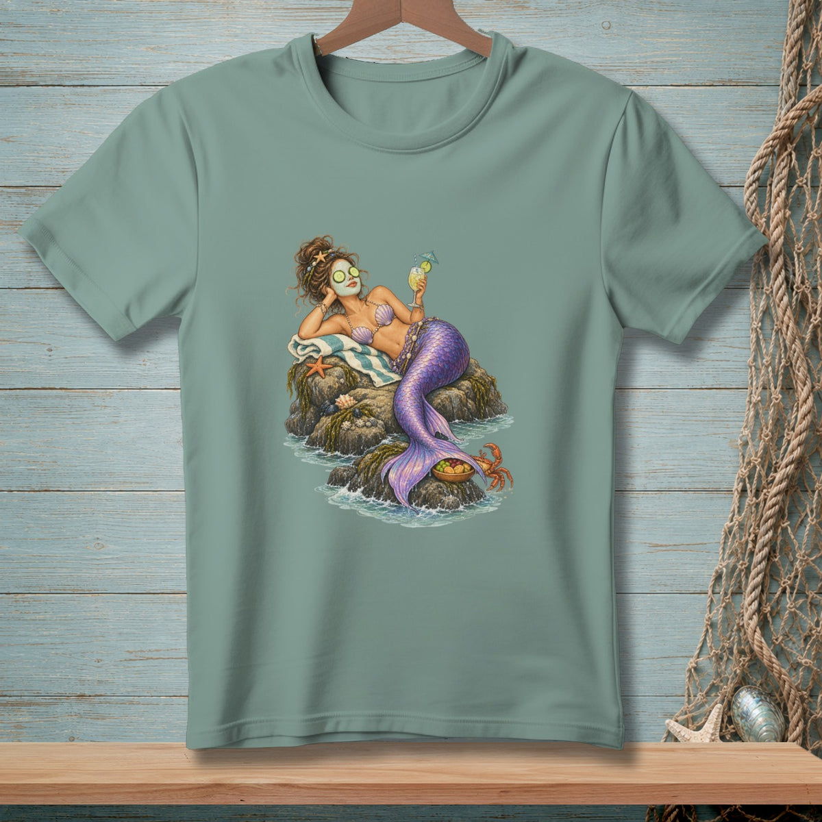 Mermaid with cucumber eye masks relaxes on rocks with a drink and a crab.