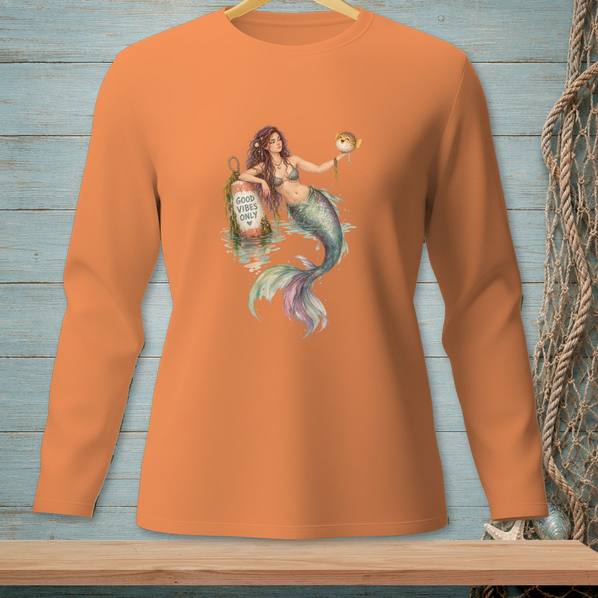 Mermaid holding a pufferfish next to a buoy with "Good Vibes Only".