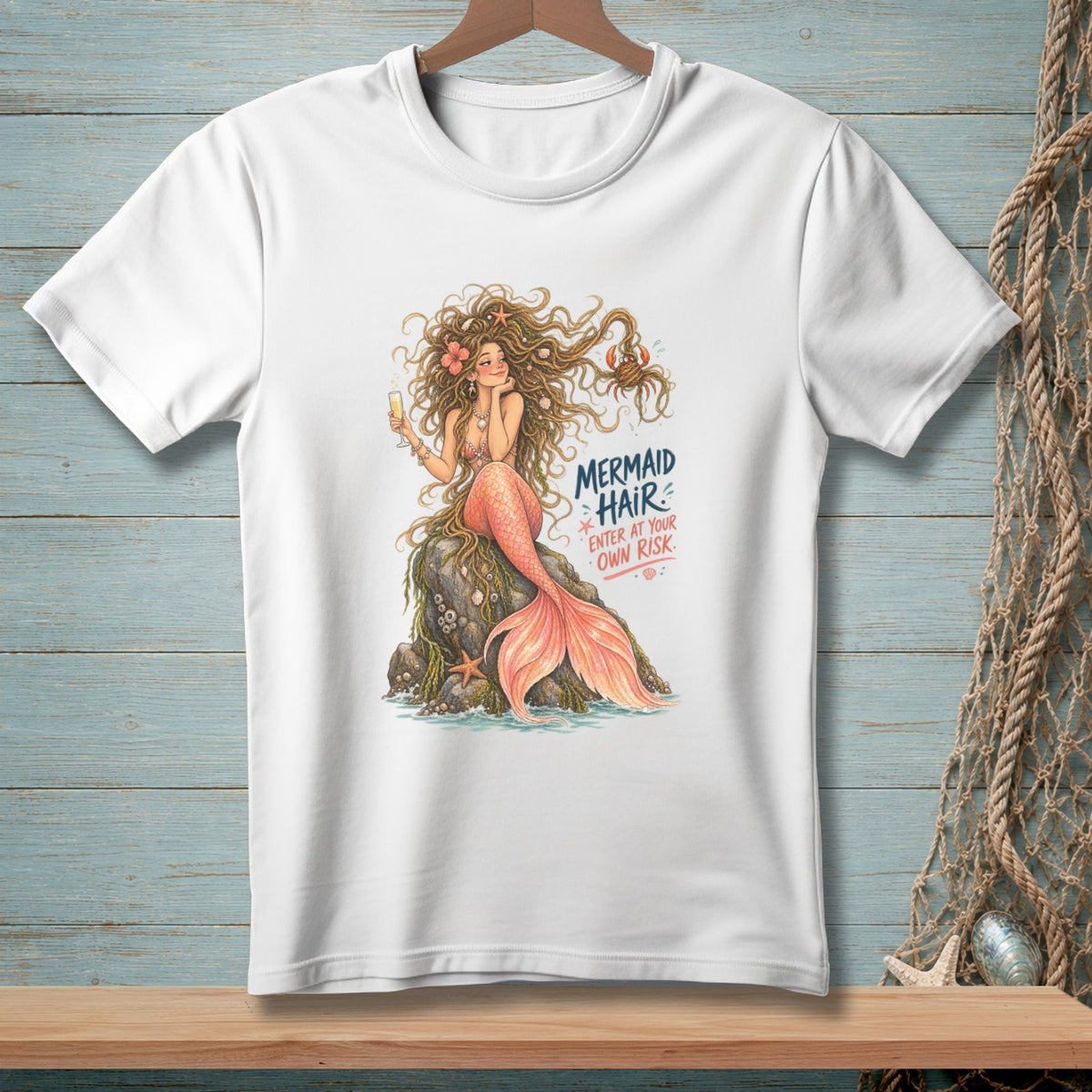 White t-shirt with mermaid illustration and text "MERMAID HAIR. ENTER AT YOUR OWN RISK."