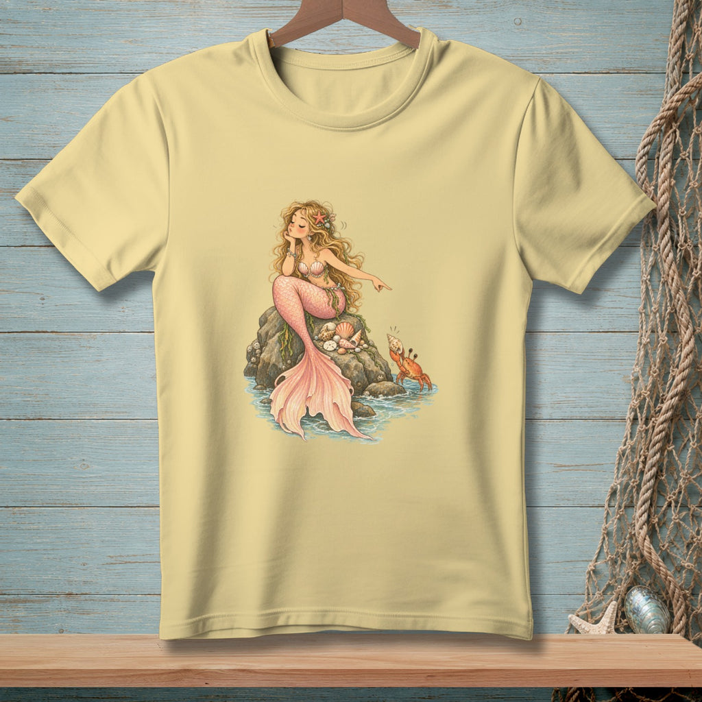 Yellow t-shirt with a drawing of a mermaid pointing at a crab on a rock.
