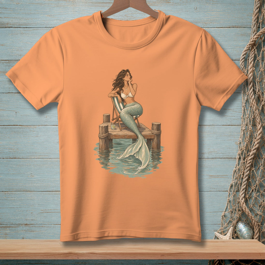 Mermaid on dock with tail in water, wearing bikini top and sunglasses.