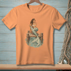 Mermaid on dock with tail in water, wearing bikini top and sunglasses.