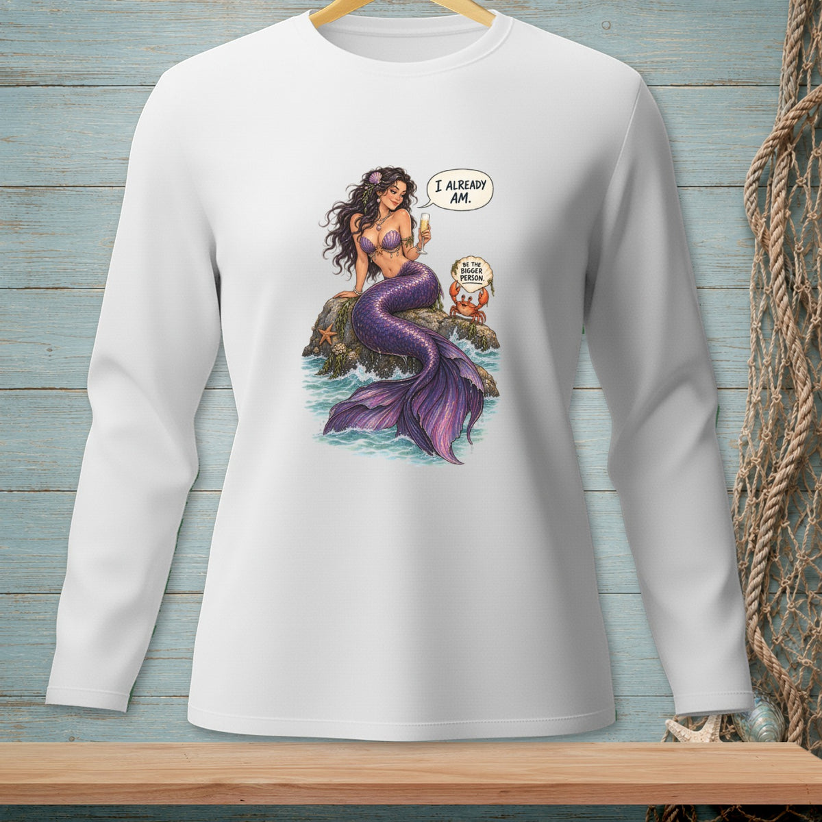 Mermaid sitting on rock with crab, saying "I already am. Be the bigger person."