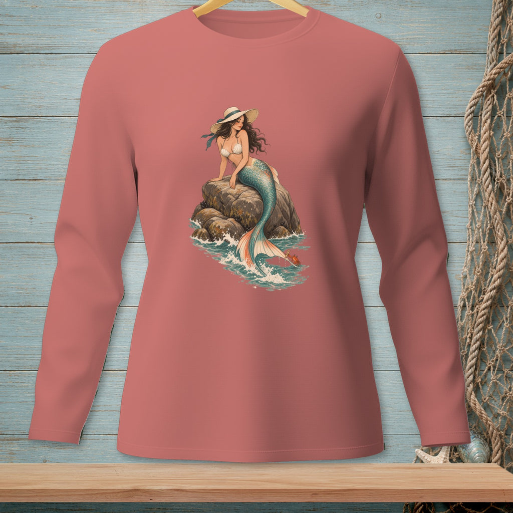 Pink long-sleeve shirt featuring a mermaid sitting on rocks in the ocean.
