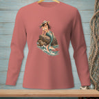 Pink long-sleeve shirt featuring a mermaid sitting on rocks in the ocean.