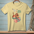 Light yellow t-shirt with mermaid, buoy, and seagull graphic and text.