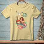 Light yellow t-shirt with mermaid, buoy, and seagull graphic and text.