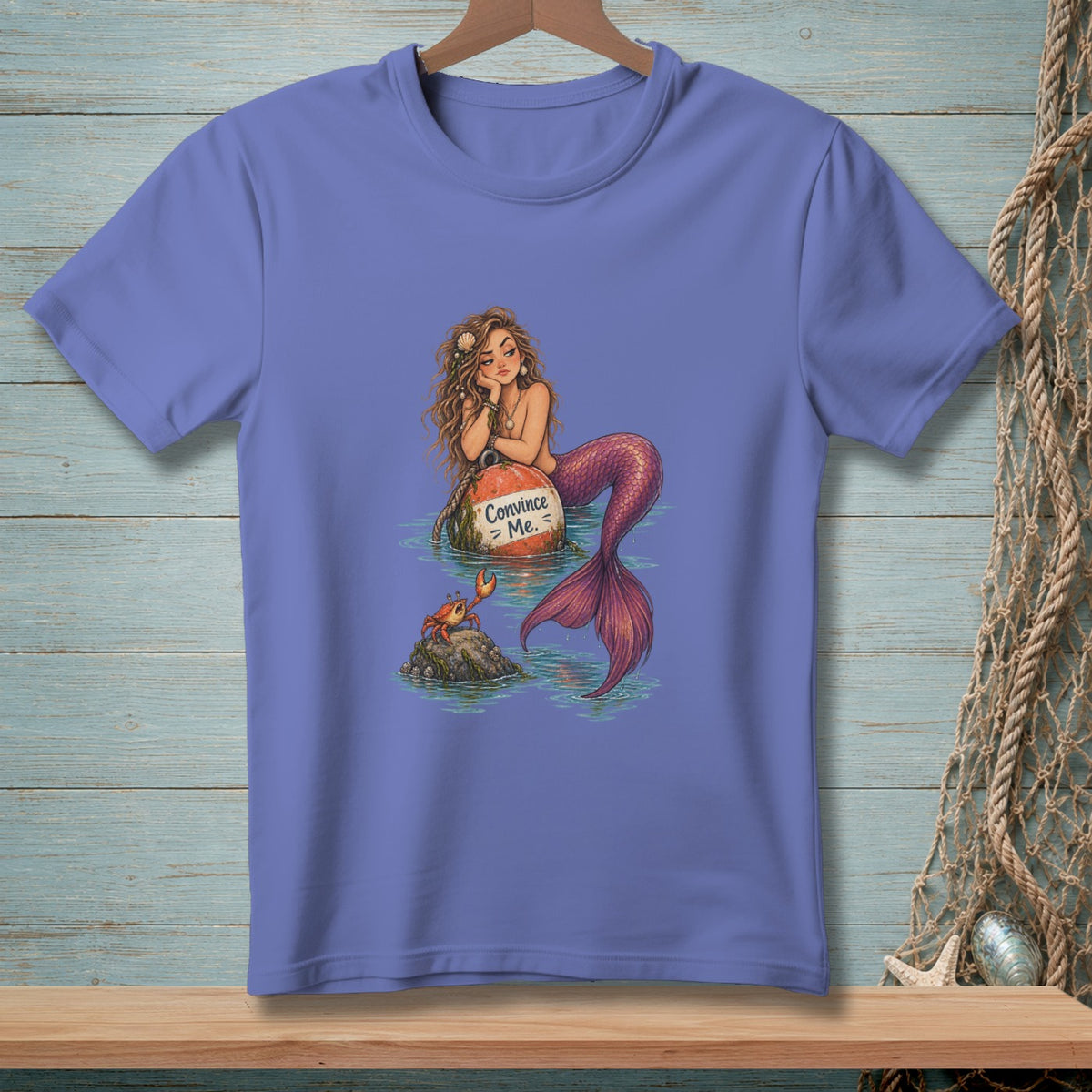Mermaid on a buoy with "Convince Me." text, a crab on a rock.
