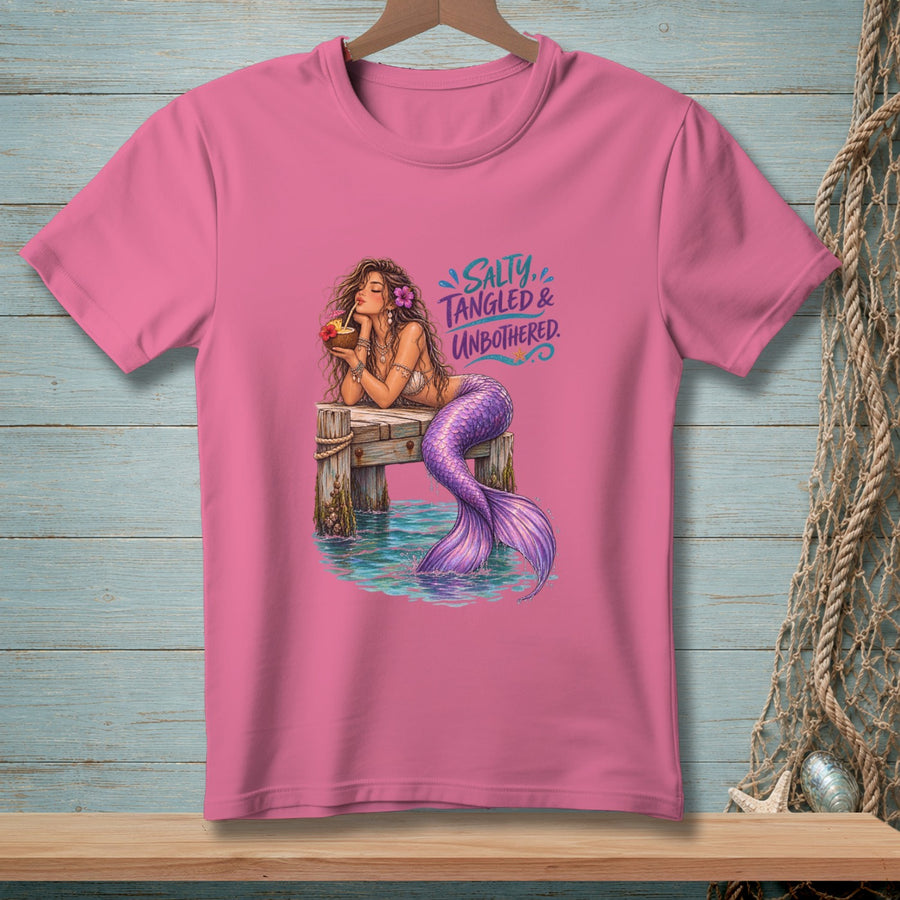 Pink t-shirt with a mermaid on a dock, text "SALTY, TANGLED & UNBOTHERED."
