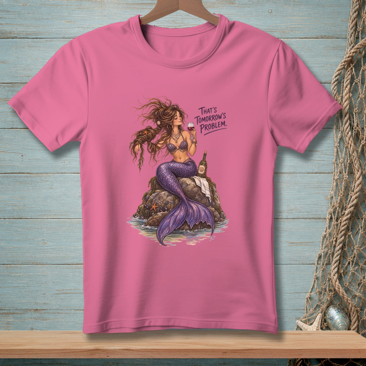 Pink t-shirt with illustration of a mermaid holding a drink and text "THAT'S TOMORROW'S PROBLEM."