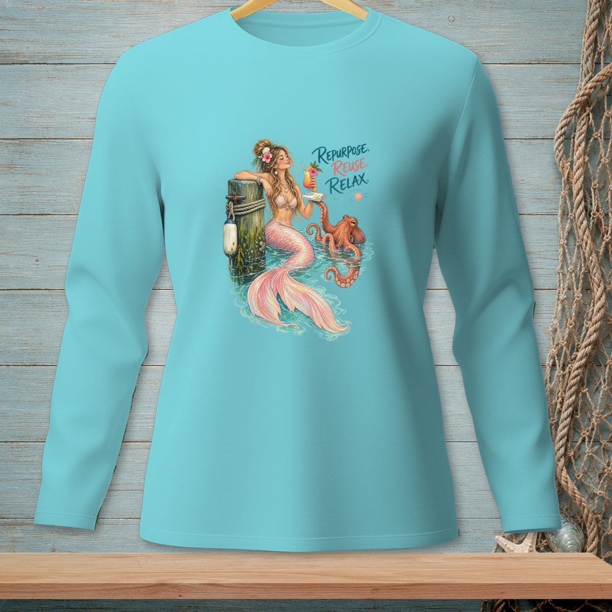 Turquoise long-sleeve shirt featuring a mermaid and octopus with text "Repurpose. Reuse. Relax."