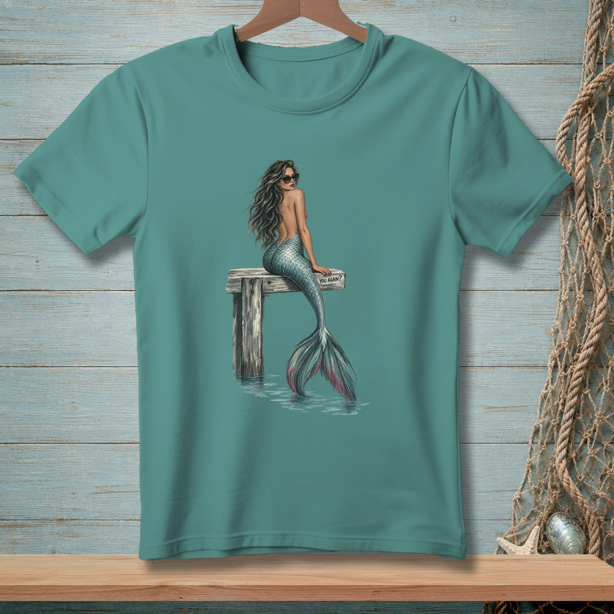 Mermaid with sunglasses sitting on a pier, text reads "YOU AGAIN?".