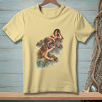 Light yellow t-shirt with a watercolor-style print of two mermaids on rocks in water.