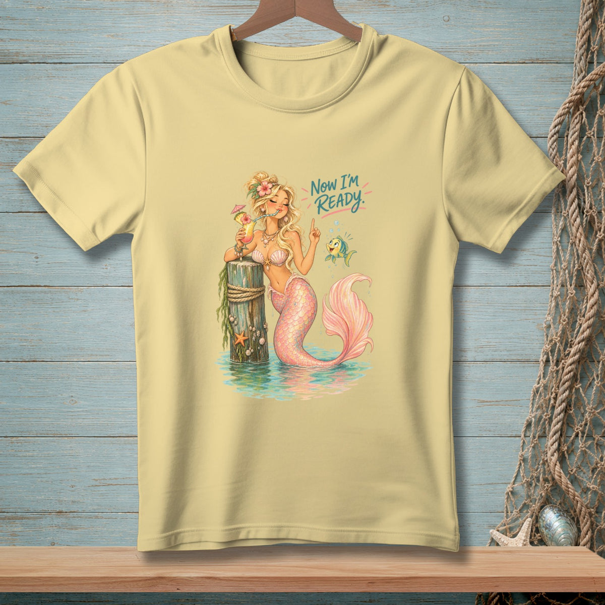 Light yellow t-shirt with a mermaid holding a drink and the text "Now I'm Ready".