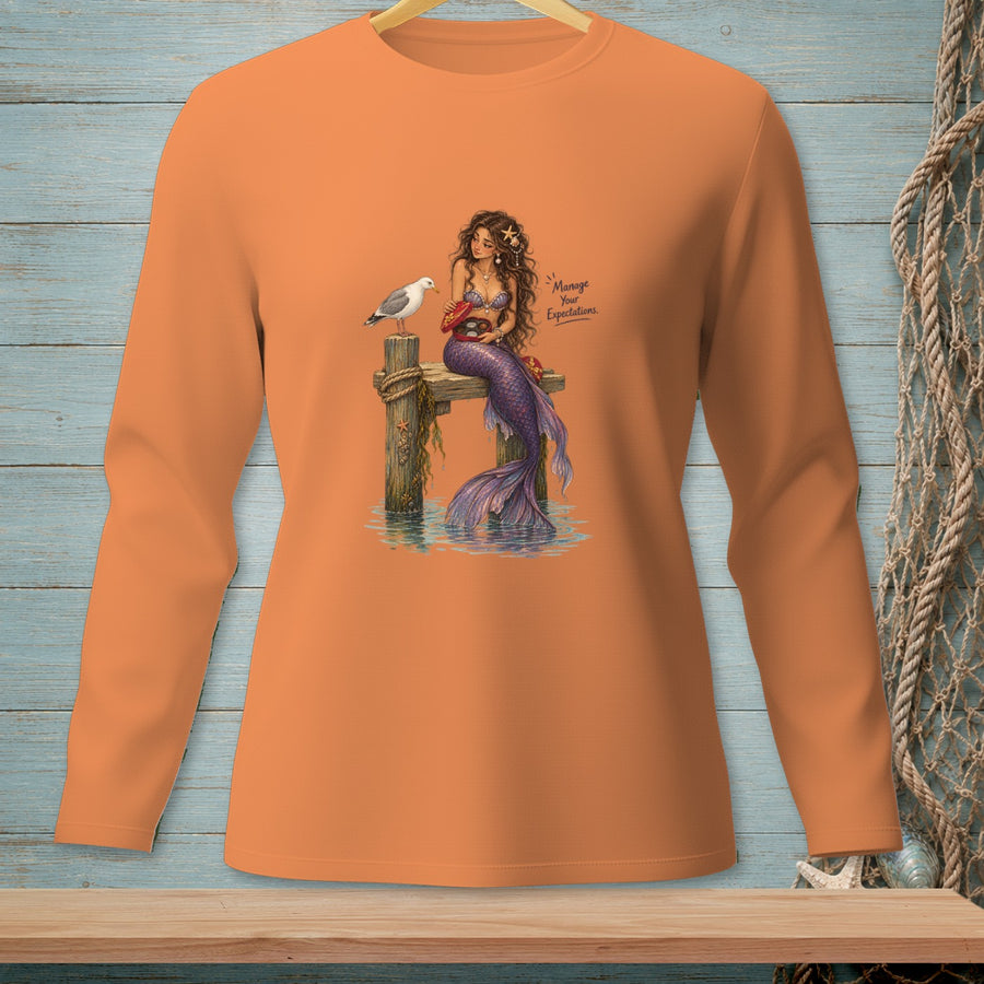 Mermaid with a seagull on a pier, holding a box of chocolates.