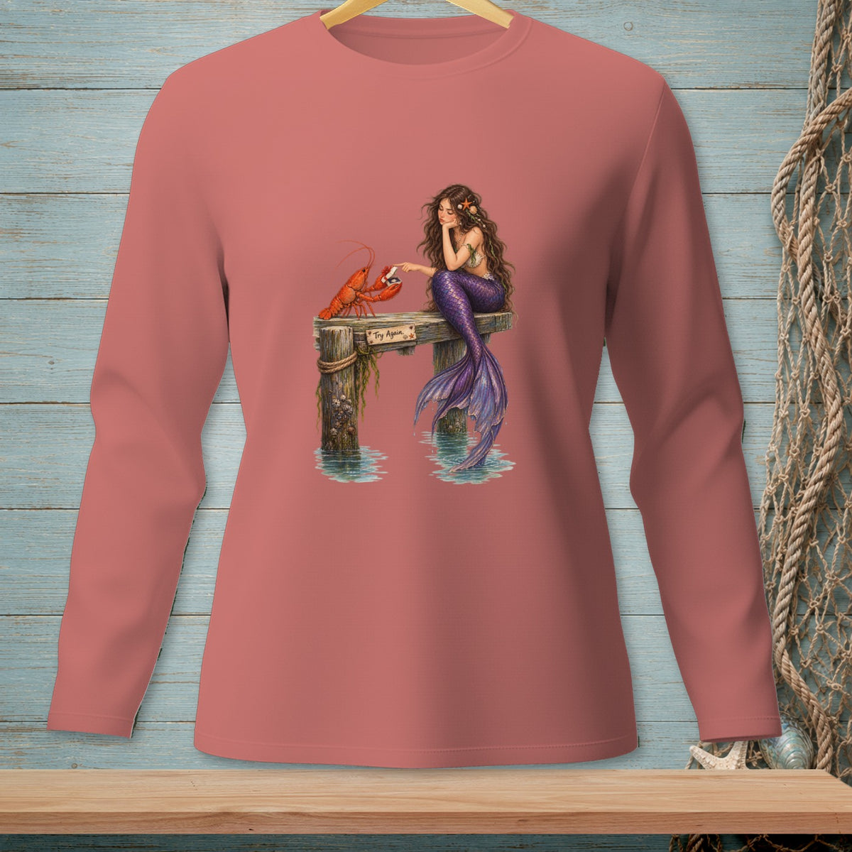 Mermaid sitting on pier with lobster, text "Try Again".
