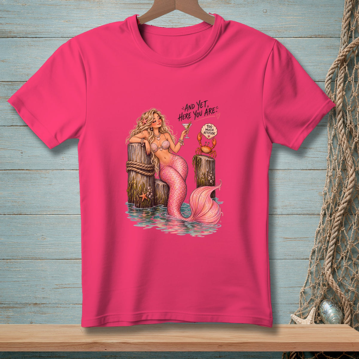 Pink t-shirt with a mermaid holding a cocktail and a crab with text.
