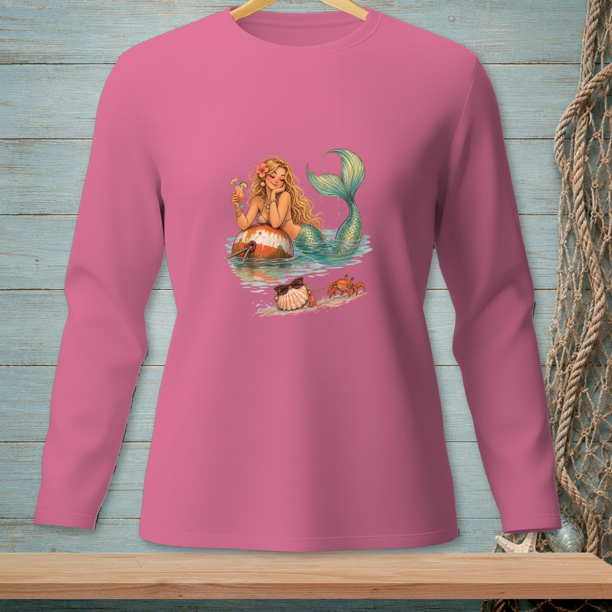 Pink long-sleeved shirt with a mermaid, crab, and seashell graphic on the front.