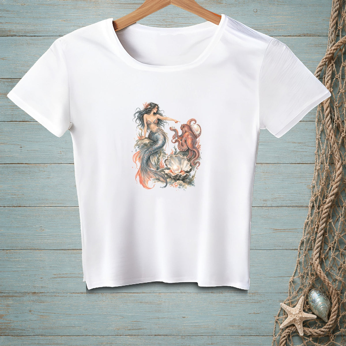 White t-shirt with a watercolor print of a mermaid and octopus with a pearl in a shell.