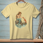 Mermaid with lobster and pearl on rock by the water.