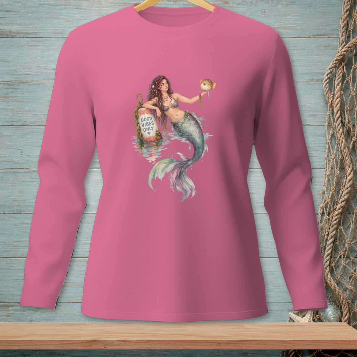 Mermaid holding a pufferfish and a buoy reading "Good Vibes Only".