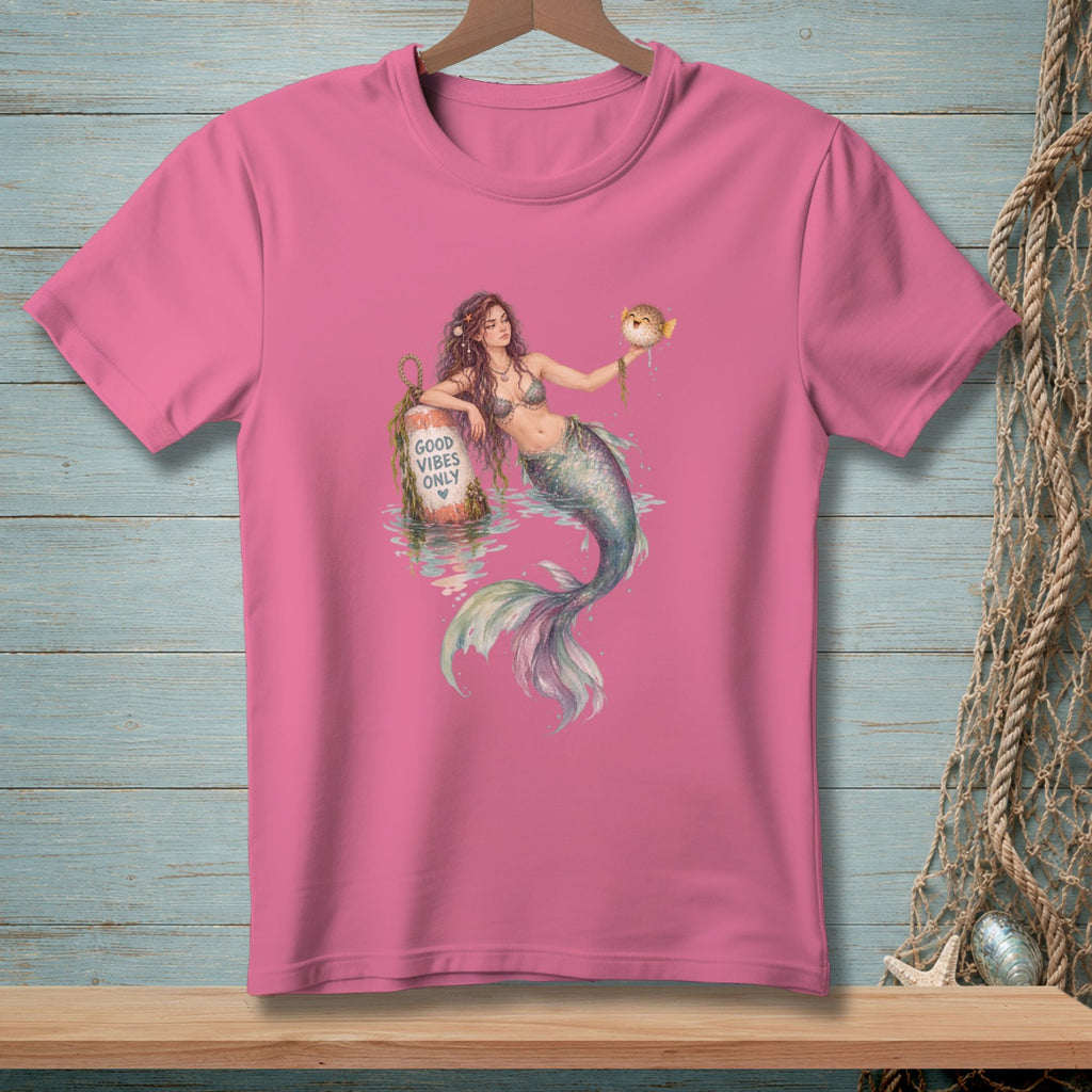 Pink t-shirt with mermaid holding a pufferfish and a buoy saying "GOOD VIBES ONLY".