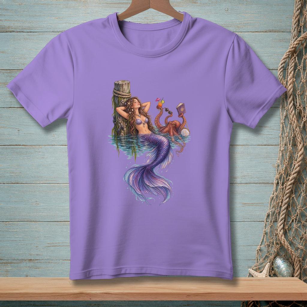 Mermaid relaxing by a pier with an octopus holding drinks and a book.