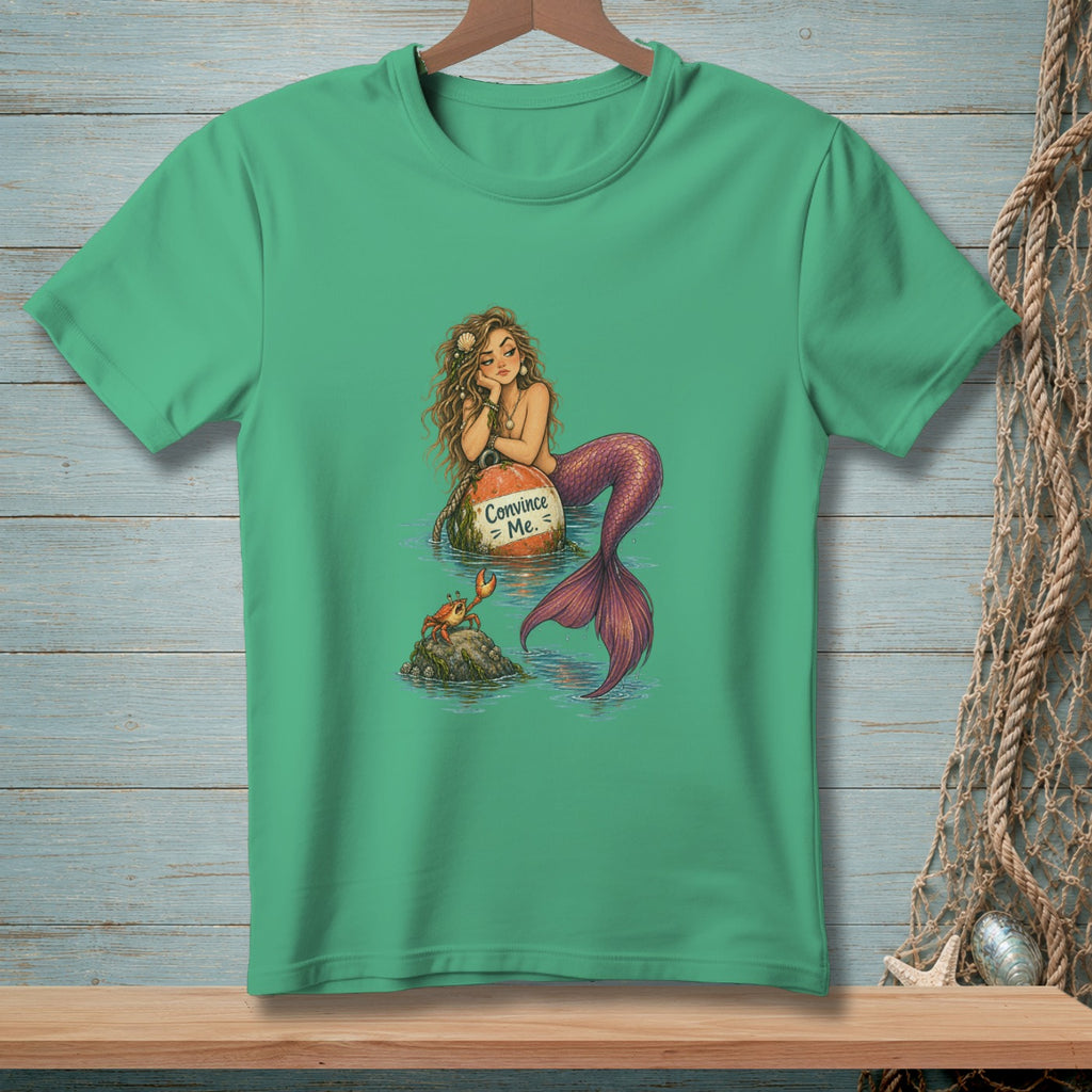 Mermaid rests on a buoy with "Convince Me." text, looking at a crab.