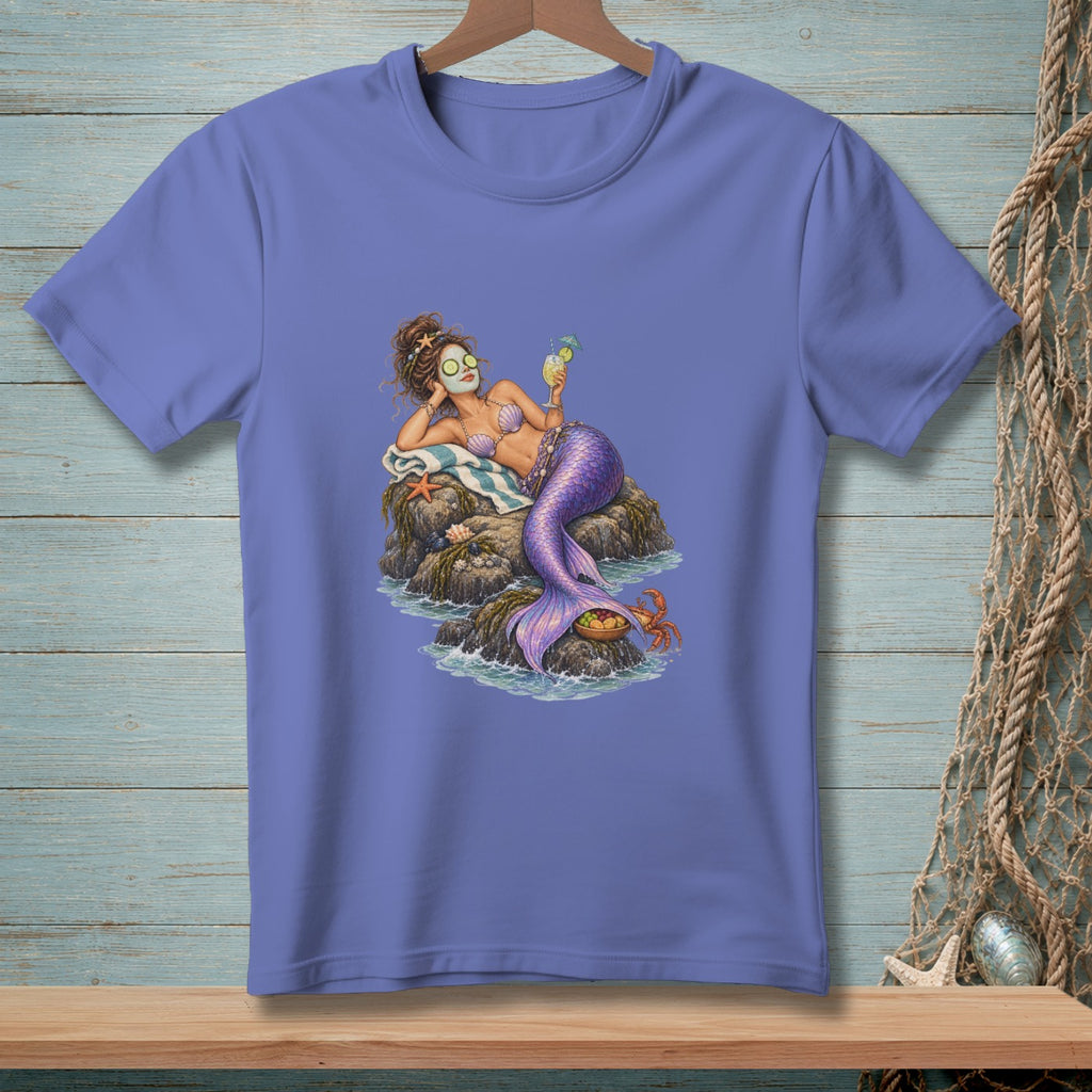 Mermaid with cucumber eyes, face mask, and drink on a rock with a crab.