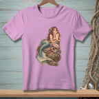 Purple t-shirt with a detailed illustration of a mermaid sitting on rocks with shells.
