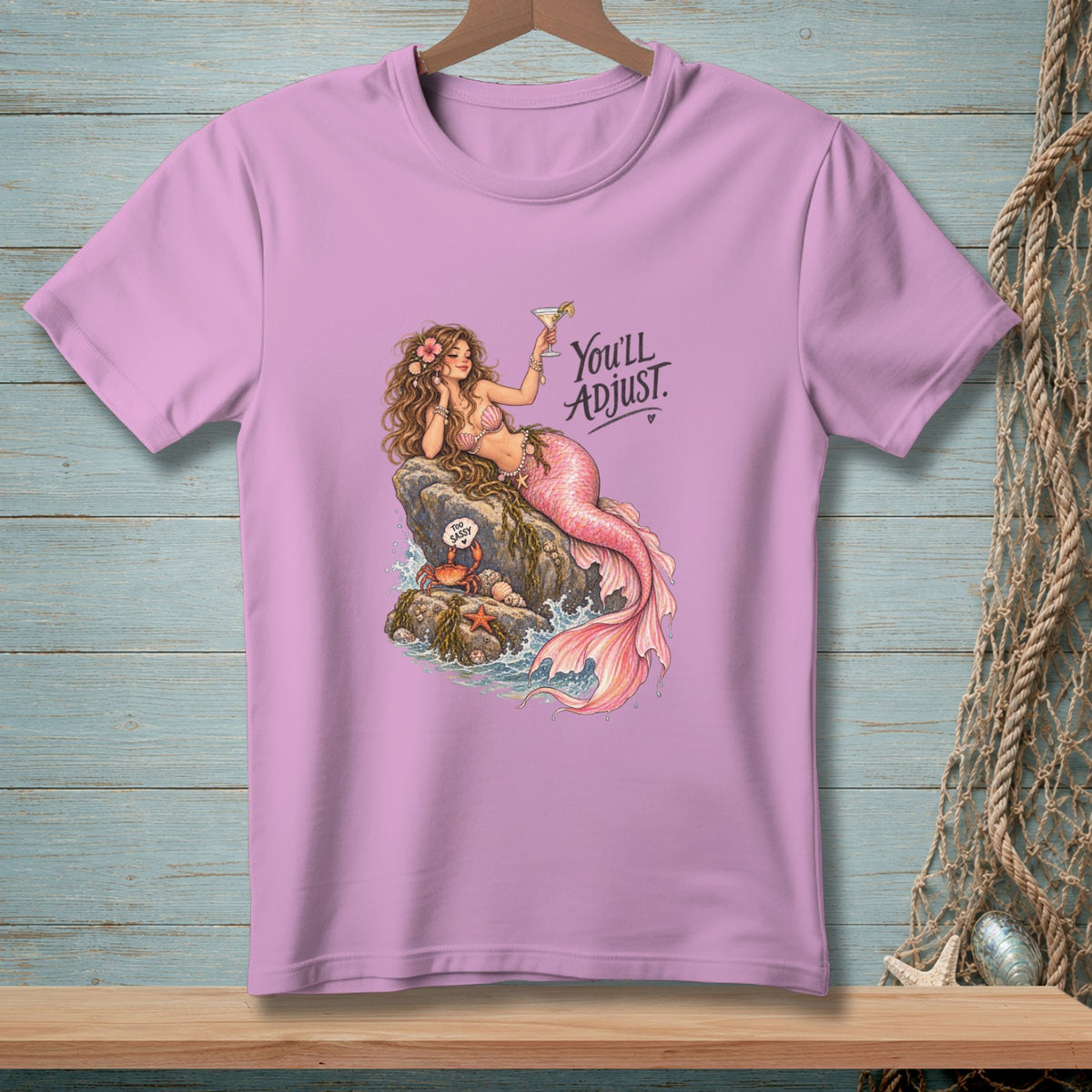 Pink t-shirt with a mermaid, crab, and text "You'll ADJUST."