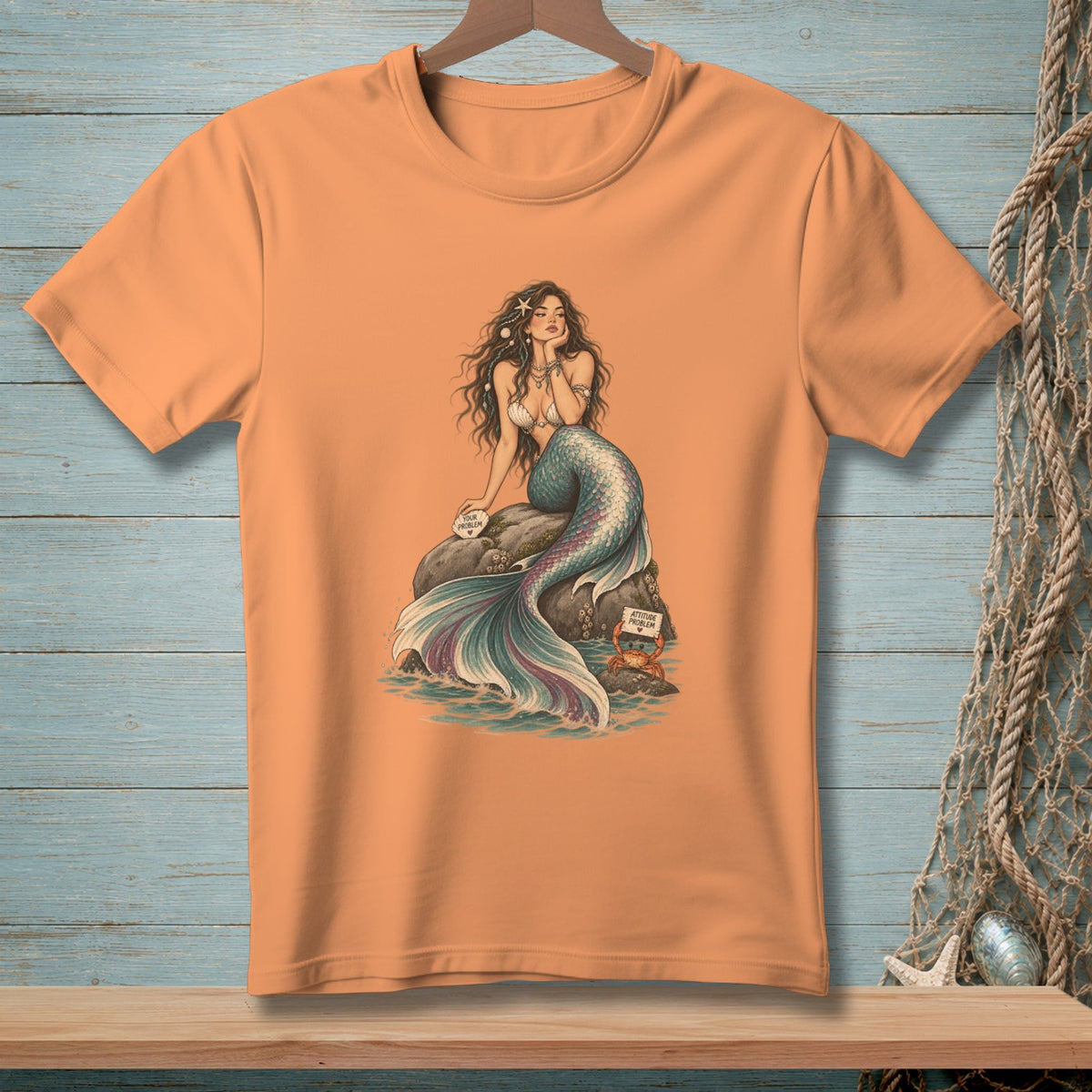 Orange t-shirt with mermaid and crab art, featuring text "Your Problem".