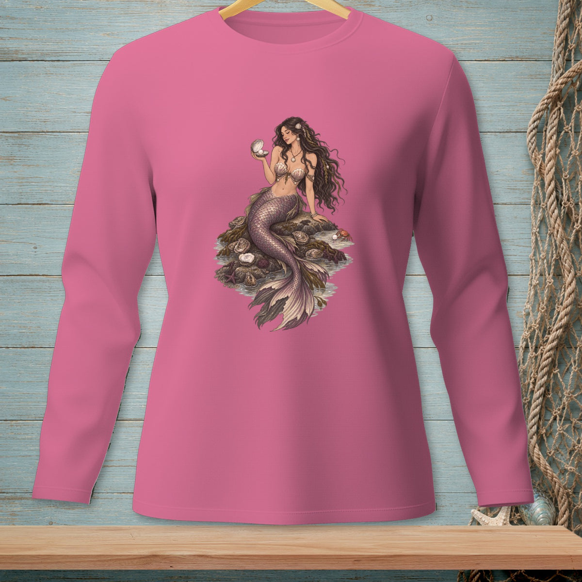 Pink long-sleeve shirt with a detailed print of a mermaid holding a pearl.