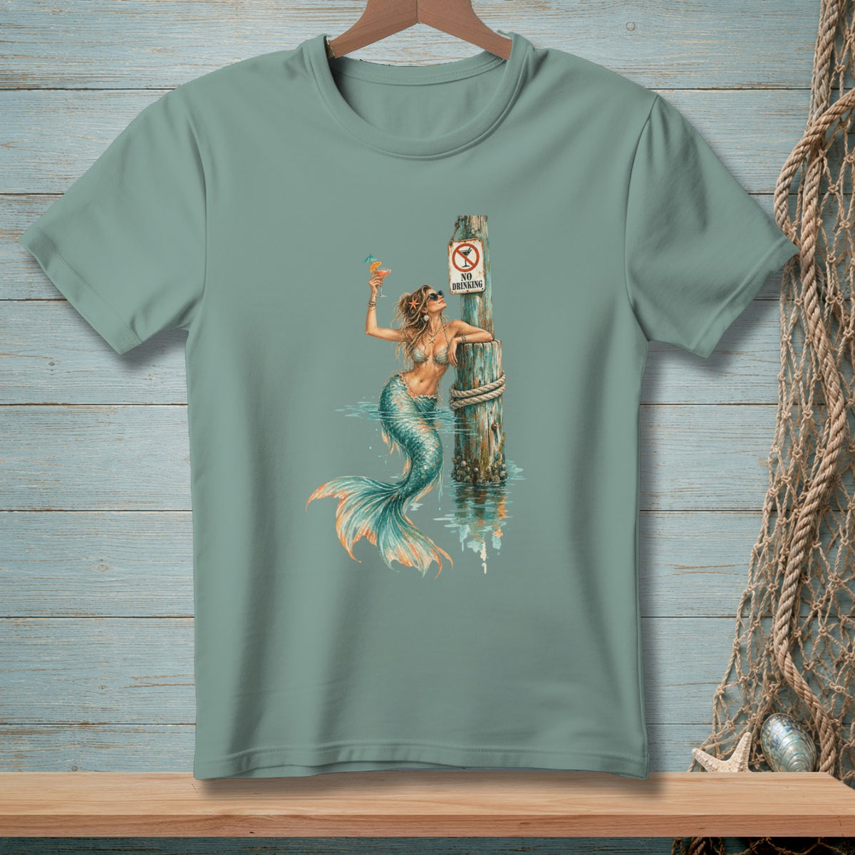 Mermaid with a drink leans on a pole with a "No Drinking" sign.