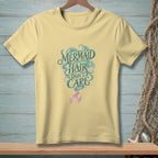 Yellow t-shirt with "Mermaid Hair Don't Care" graphic and a pink mermaid tail.