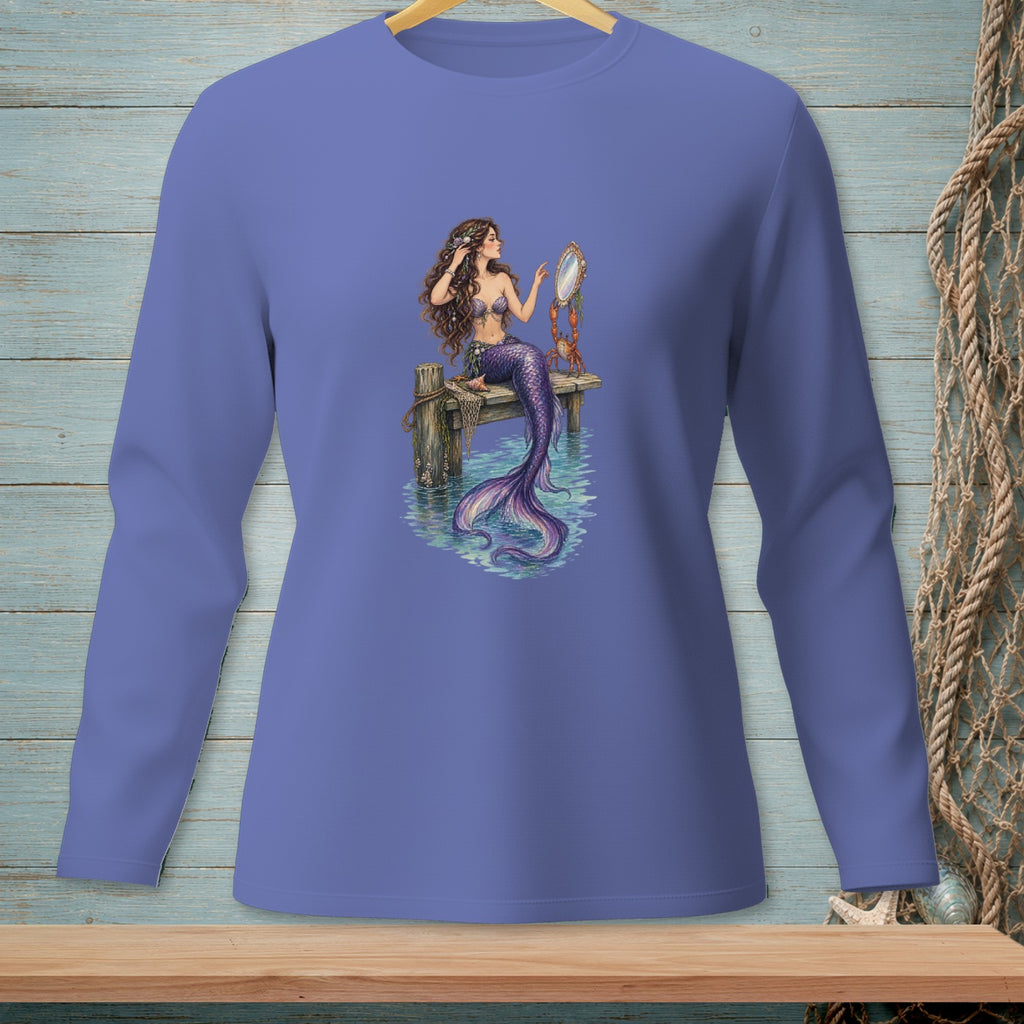 Mermaid sitting on dock, looking in mirror with purple tail.