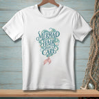 White t-shirt with "Mermaid Hair Don't Care" text and mermaid tail design.