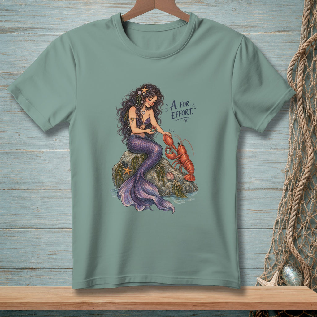 Mermaid with purple tail interacting with a lobster, text reads "A for Effort".