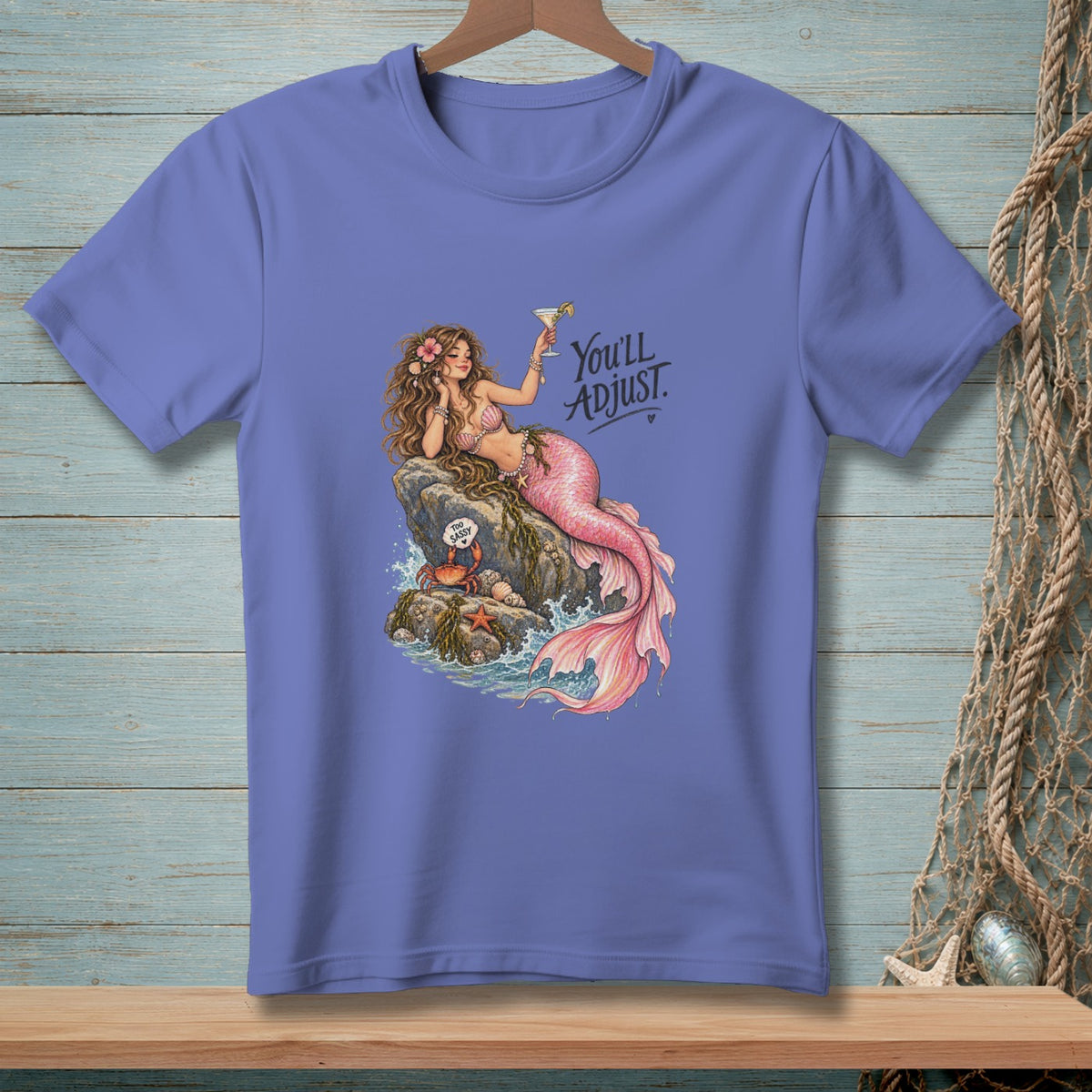 Mermaid with pink tail and drink on rock with crab, text "You'll ADJUST."