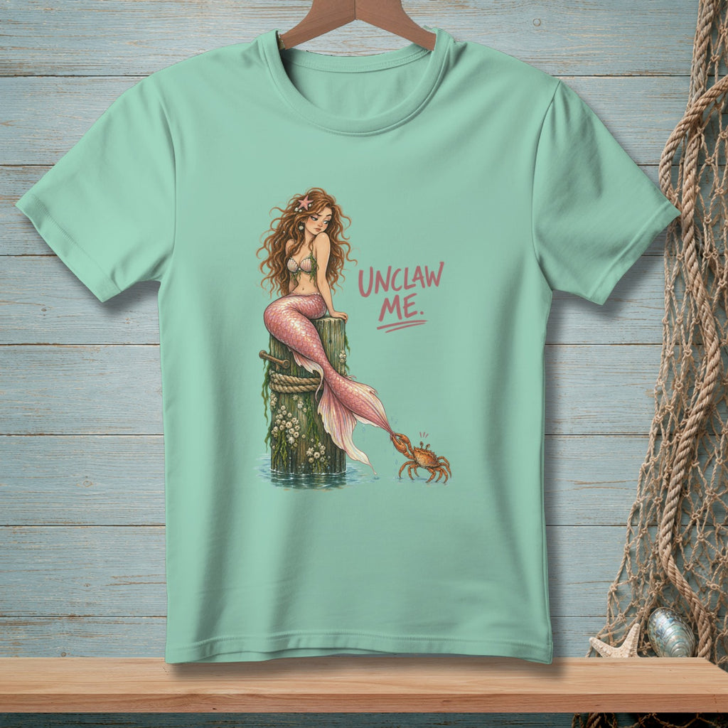 Mint t-shirt with mermaid on post and crab with text "UNCLAW ME."