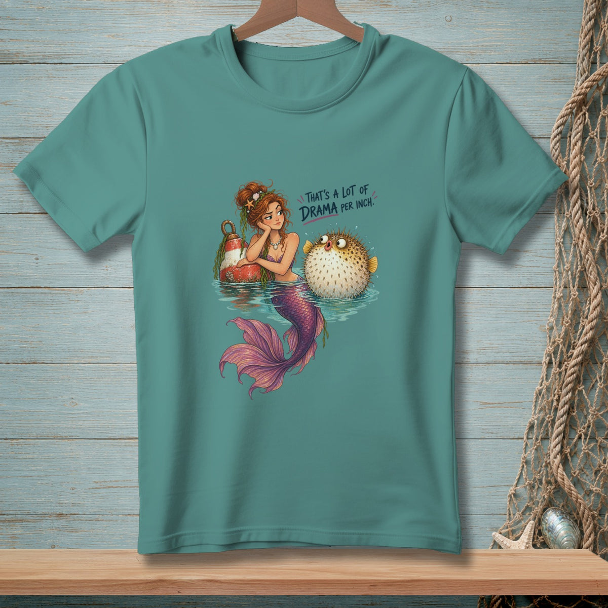 Mermaid and pufferfish with text "That's a lot of drama per inch."