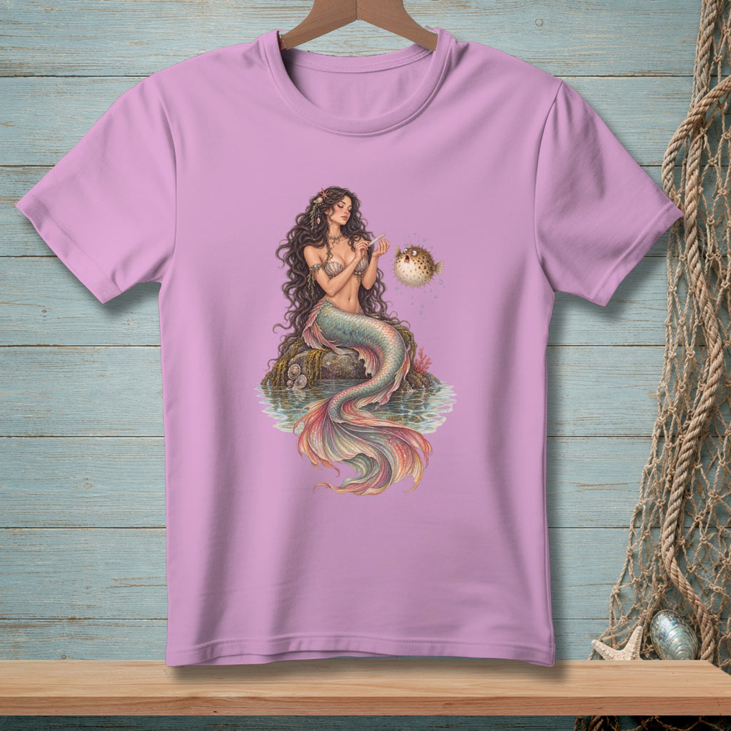 Pink t-shirt with a mermaid sitting on rocks with a pufferfish.